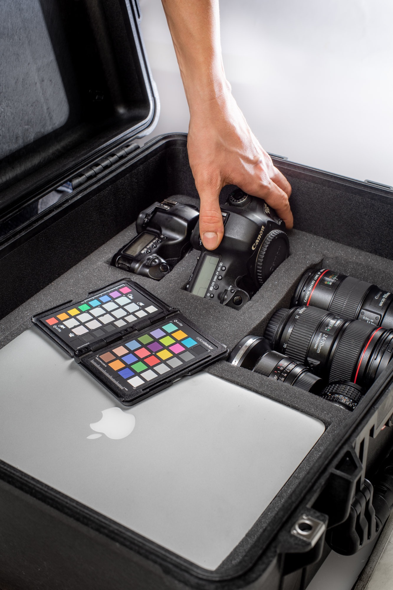 A hand reaching for a camera