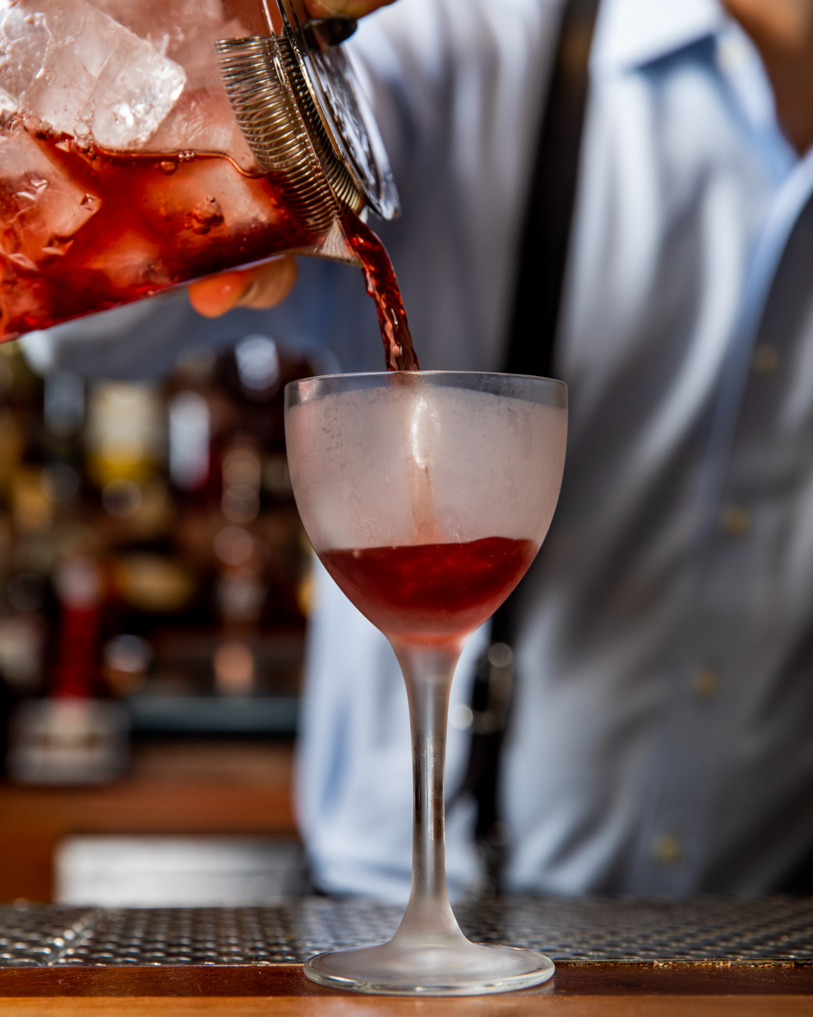 Pouring a cocktail into a glass